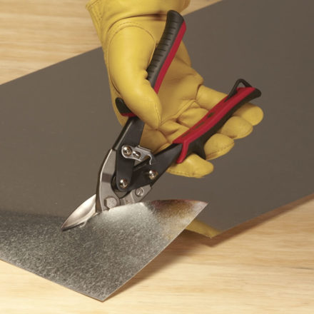 Man cutting a piece of Sheet Metal with Malco's AV1 Aviation Snip