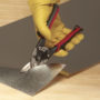 Man cutting a piece of Sheet Metal with Malco's AV1 Aviation Snip