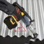 Person cutting off a strip of corrugated metal roofing with a Malco TSCM shear
