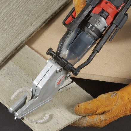 Person using a Malco TSF1 Fiber Cement TurboShear to cut off a section of Hardie Board