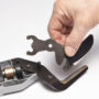 A person replacing the cutter blades of the Malco TSV1 Vinyl Siding Shear