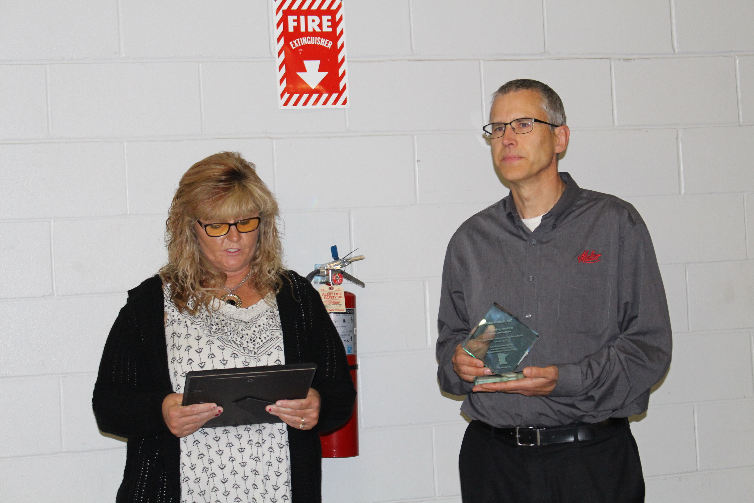 Amber Oster, Vice President of Workforce Solutions, Functional Industries, reads from her nomination letter during presentation of the Outstanding Disability Employer Award