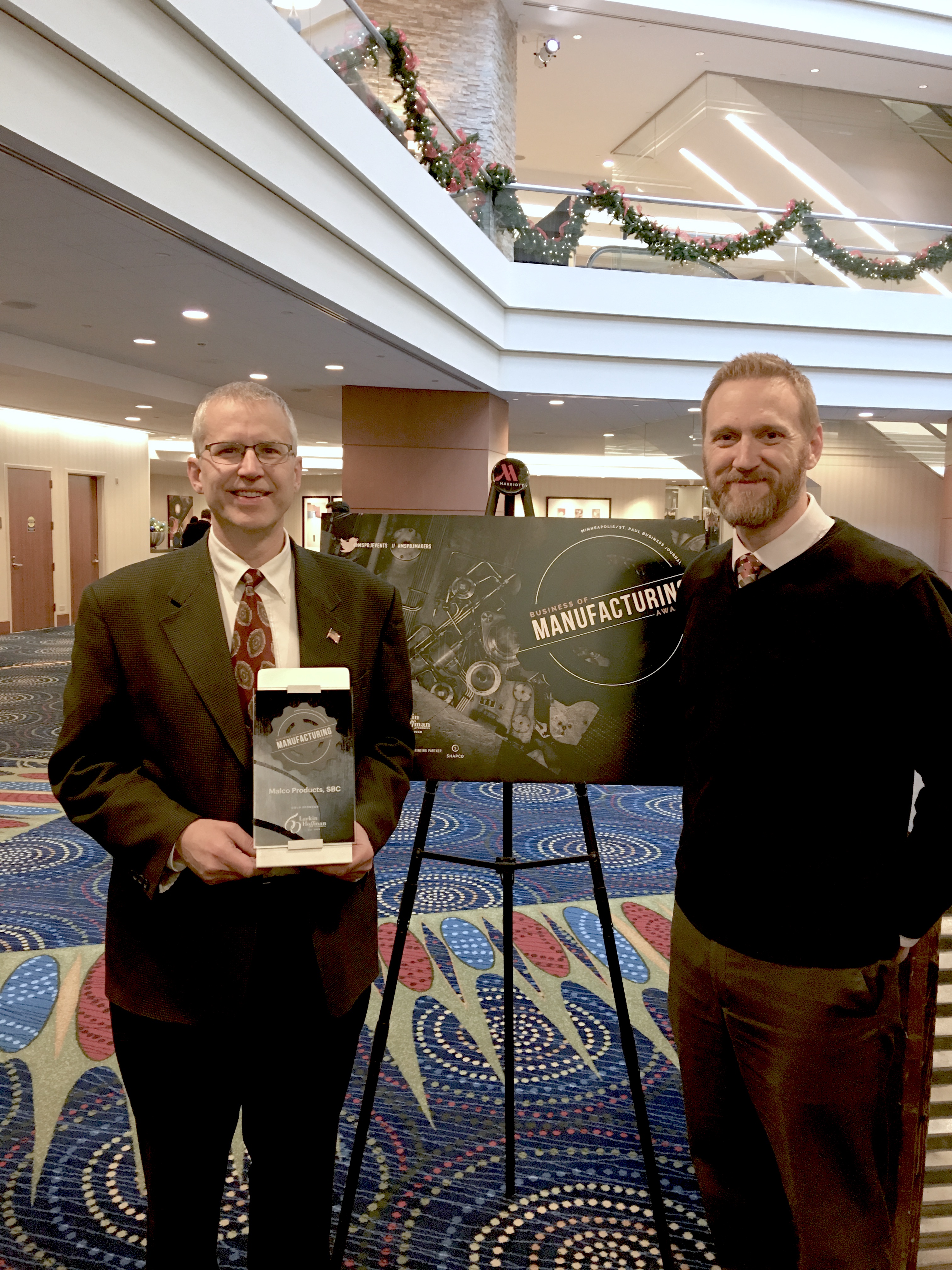 Malco President Mardon Quandt and Human Resource Manager Kirk Langbehn, accepting the 2018 Medium Manufacturer of the Year Award.