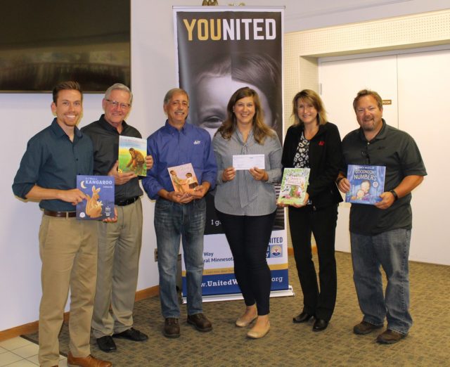 Malco Employees presenting children books for United Way donations