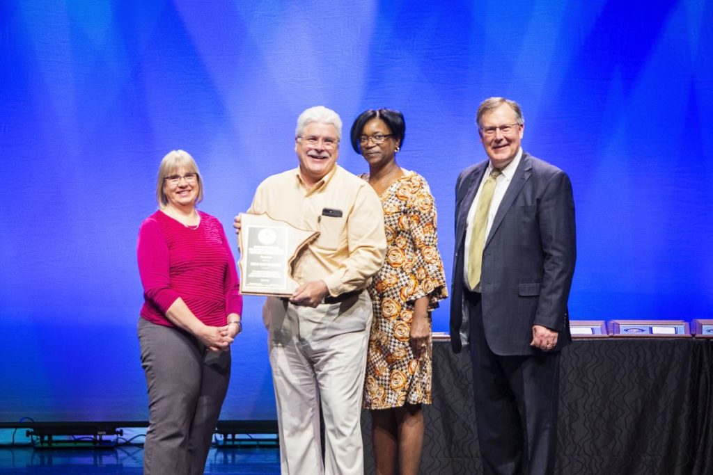 Malco Products long time employee Hap Spooner pictured holding the Arthur E. McCauley, Jr. Minnesota Occupational Safety and Health Leadership Award from the Minnesota Department of Labor and Industry.