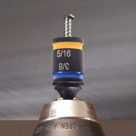 Drill with a Malco C-Rhex Magnetic Hex Driver screwing in a screw into a piece of sheet metal