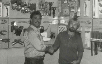 Vintage image of two Malco employees shaking hands
