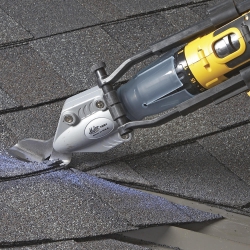 Asphalt shingles on a roof being cut with the Malco TSS1 connected to drill attachment 