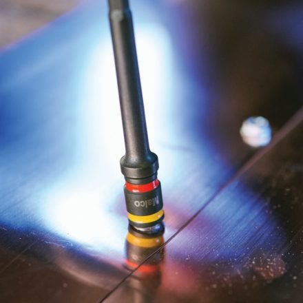 A screw being fastened with a Malco 7 and 8 MM CRHEX in a piece of sheet metal