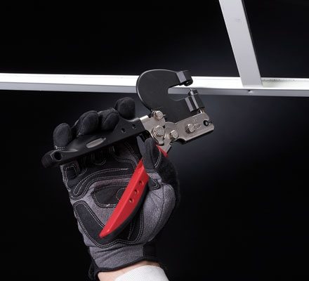 Man using Malco Ceiling Grid Punch on white grid