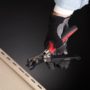 Person using Malco's Nail Hole Punch on a section of vinyl siding