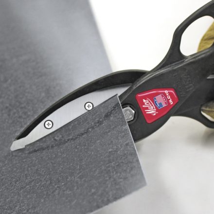 Malco Lightweight Metal Cutting Snips cutting a piece of sheet metal