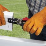 Man notching Vinyl Fence with Malco VFN2 Tool